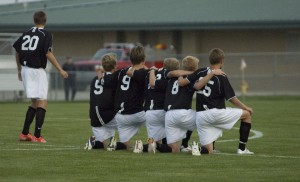 The Cougar's kneel together in apprehension, watching the penalty kick shootout. Senior John Mcnair scored the winning penalty kick goal, beating the Mustangs 5-4.