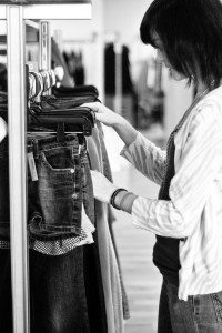 Photo by Hannah Williams Junior Haylee Slocum looks through clothes at Ditto consignment store in Overland Park. “I just wear what I feel like. And whatever feels comfortable or looks cute that day. I don’t really have a set style,” Slocum said.